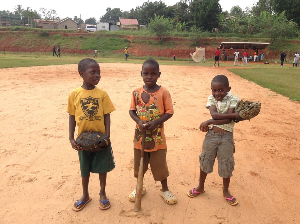 Three boys with baseball gear at Buyinja Primary School
