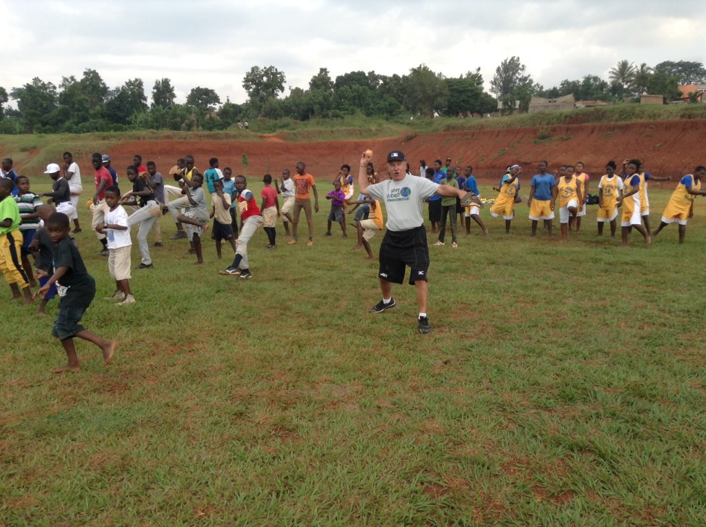 Play Global coach demonstrating throwing with Kenyan youth