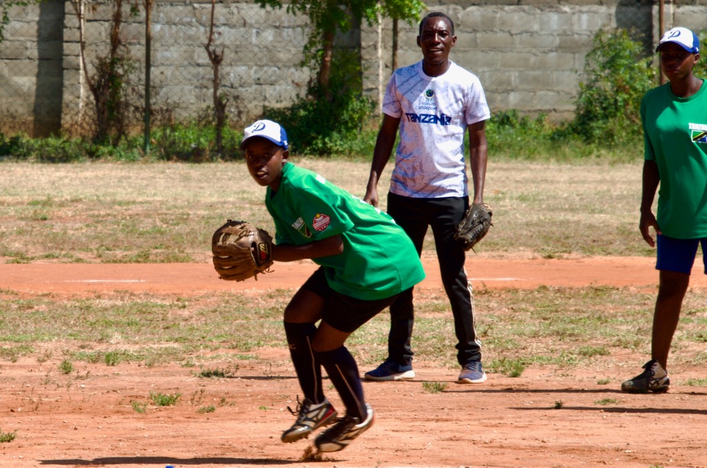 Young player catching ball during Tanzania baseball practice